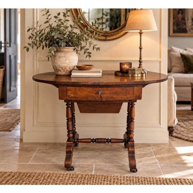 An elegant English Victorian work table, circa 1835-1860 (William IV/early Victoria period), crafted from walnut or...
