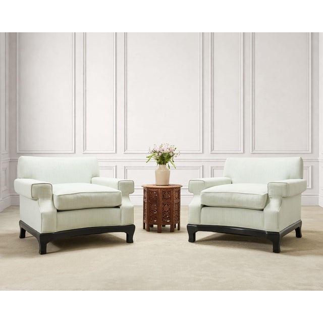 An exceptional pair of "No. 619" mint white upholstered Ming style lounge chairs made by A. Rudin, Los Angeles, CA. The...