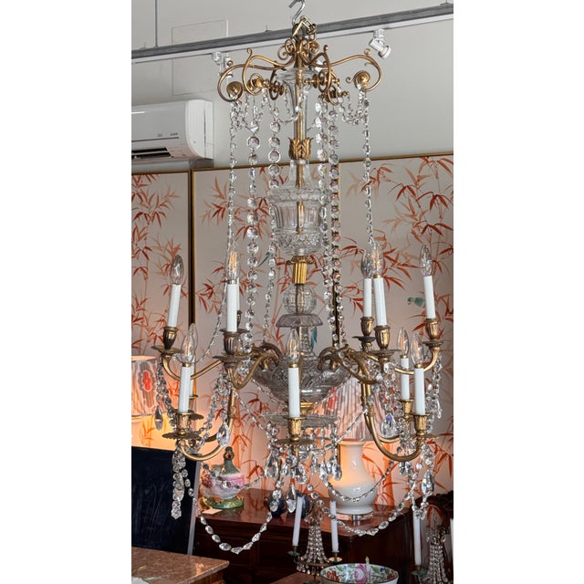 An early 19th C. Anglo-Irish chandelier combining richly cut crystal elements with finely cast gilt bronze arms and...