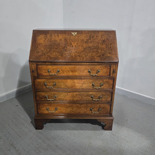 A very nice four drawer Queen Anne burr walnut bureau, leather writing surface, in excellent overall condition.