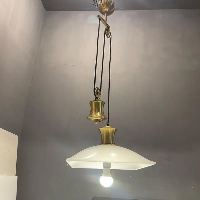 Acrylic light pendant 1980’s brass fittings with white plastic acrylic shade maximum height 172 cm minimum height 105 cm...