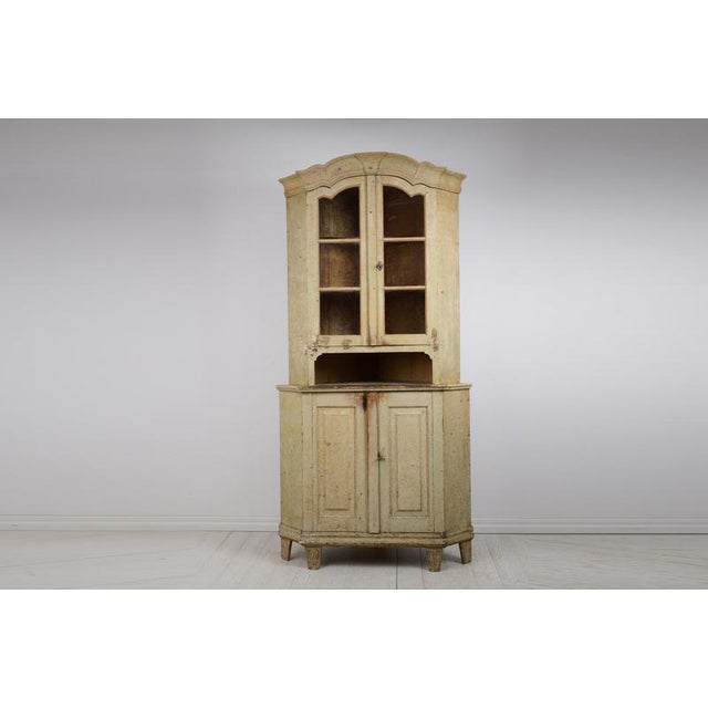 Rare gustavian period corner cabinet with glass doors from Sweden made during the 1790s. The cabinet is made by hand in...