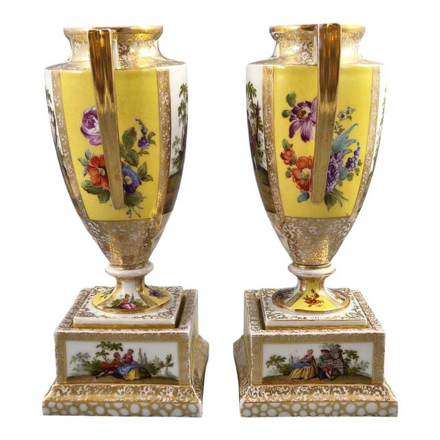 A superb pair of late nineteenth-century Dresden porcelain urns on separate square pedestals, produced by the renowned...