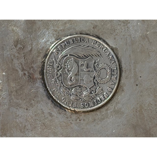 Handcrafted Peruvian sterling silver tray featuring an authentic 1882 Peruvian Un Sol silver coin mounted at the center....