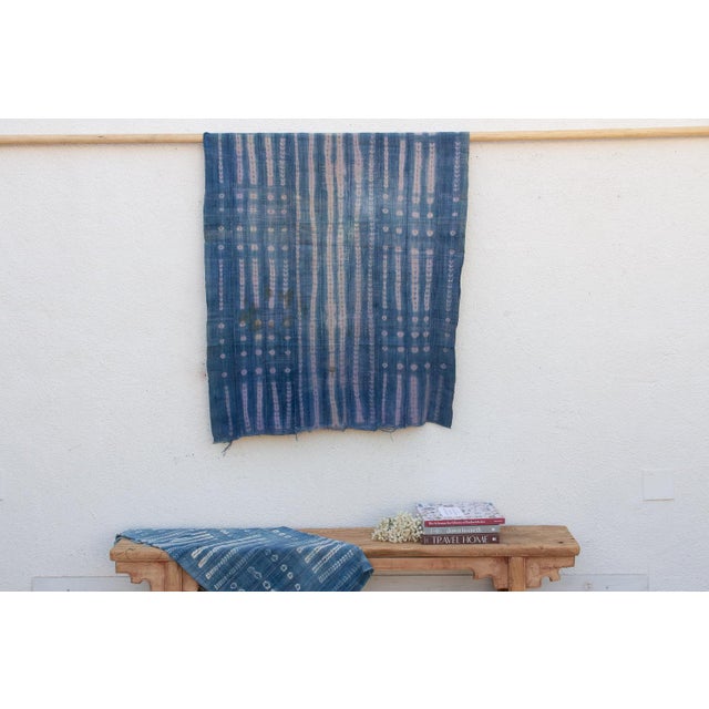 A masterwork of Malian textile heritage featuring deep indigo saturation and symbolic geometric motifs. Originating from...