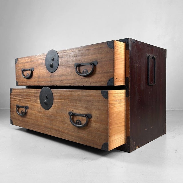 An authentic Japanese tansu chest from the Meiji period (ca. 1900), distinguished by the beautiful contrast between the...