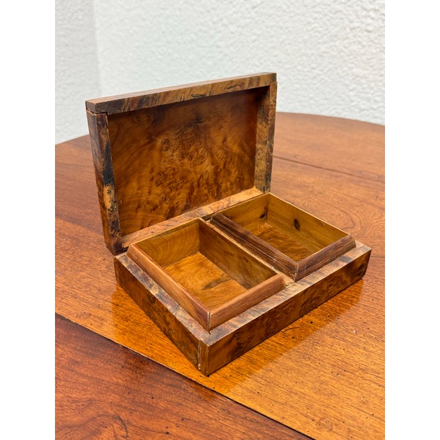 Design Plus Gallery presents a Burl Wood Hinged Keepsake Box. This rectangular box has a highly figured grain pattern,...