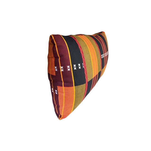 The African Kente cotton Cloth Pillow is a unique and stylish addition to any home decor, featuring a lumbar shape with...