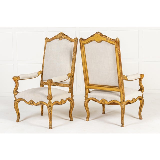 An Exceptional Pair of French Régence Style Giltwood Armchairs c.1900 These chairs were probably made in Paris, inspired...