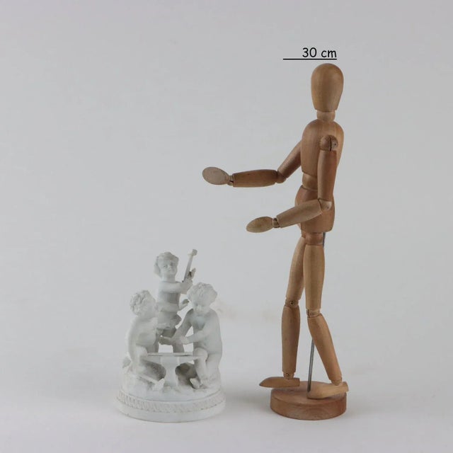 Group of biscuit cupids forging arrows. Under the base there is the manufacturer's brand. This piece is attributed to the...