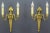 A pair of French early 20th century Louis XVI or neoclassical style gilt bronze and brass sconces. Wall lights have been...