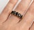 Bold, sophisticated, and timeless, this striking ring features a row of deep, captivating Black Onyx gemstones, designed...