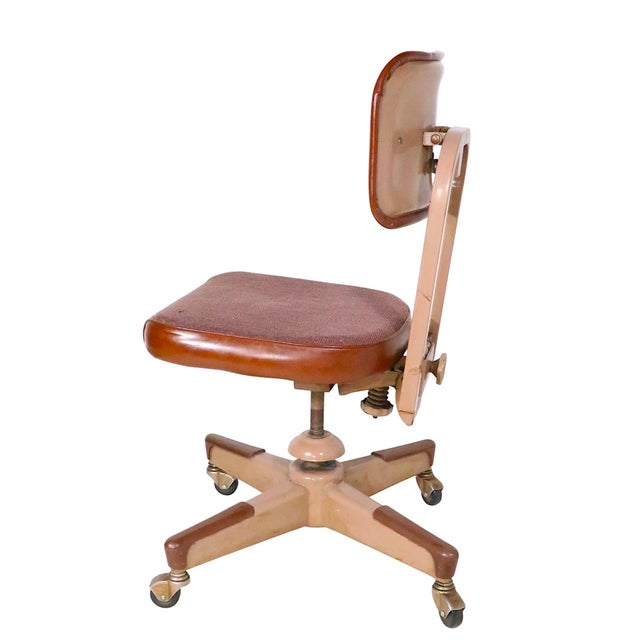 Mid Century Industrial swivel desk chair, in good, ready to use vintage condition. The chair features a metal frame, with...