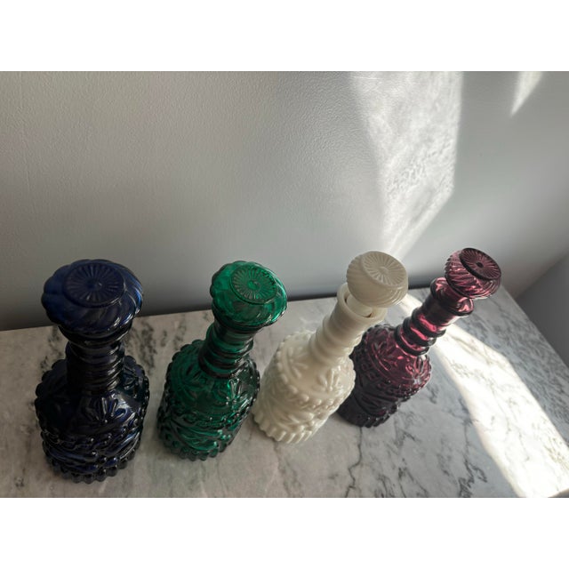 Gorgeous set of glass decanters in different colors- amethyst 1967, navy blue 1971, green 1968 and white 1969. These are...
