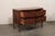 An Italian two-drawer raised side chest, with veneered burl wood and inlay banding accents, from the 18th century. This...