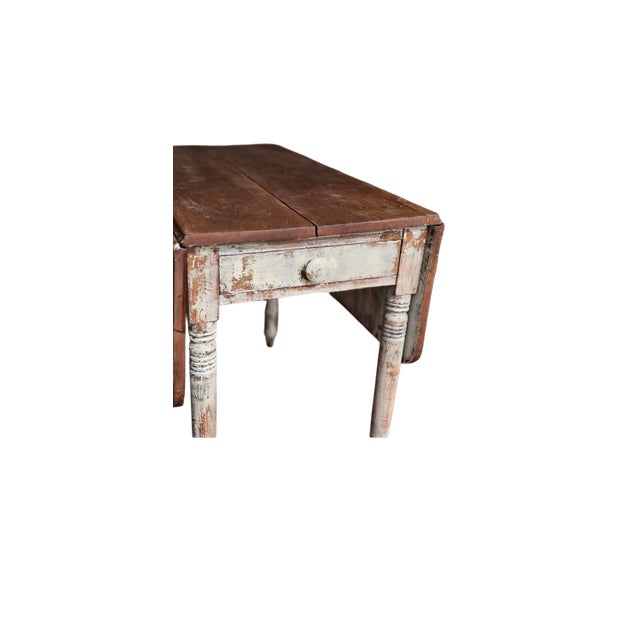 Small antique drop leaf table. white washed base, soft pine top. Dainty turned legs on casters Perfect size for a...