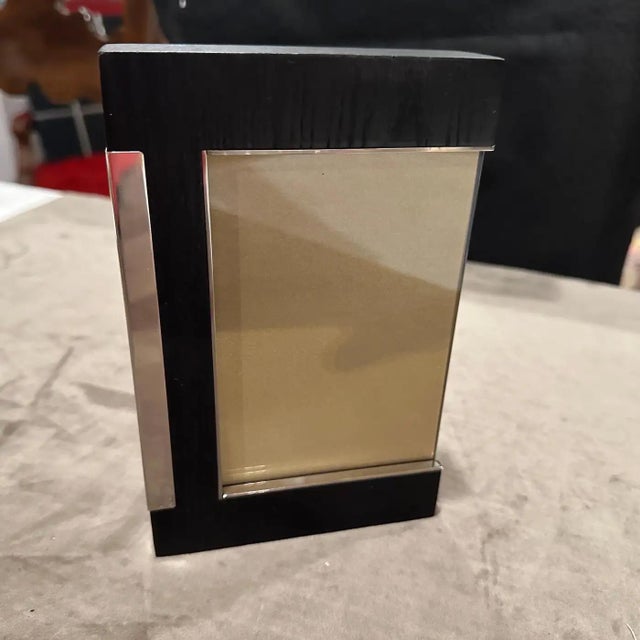 Sleek 1980s Modern Sterling Silver and Ebonized Wood Picture Frame by Silvan, Italy This exquisite picture frame is a...