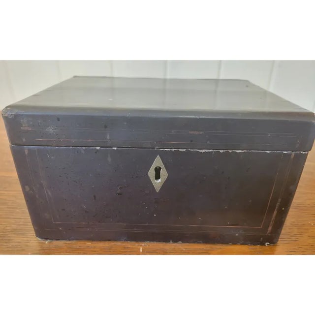 Antique Chinese Tea Caddy Chest with black lacquer and painted traditional gold edging. Two tin metal box inserts with...