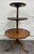 This is an elegant antique mahogany Georgian Revival or Queen Anne style three-tier dumbwaiter or tiered serving table...