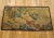 A French pastoral landscape tapestry from the 18th century, envisioning a placid scene in which a shepherd and shepherdess...