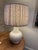 Creamy white gourd lamp with two toned lavender dot pleated fabric shade and silver ball finial. Lamp is in good working...