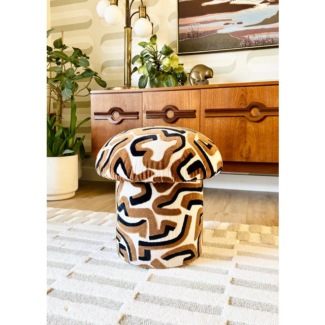 A handmade mushroom shaped ottoman, upholstered in "Serpentine" specialty fabric. Serpentine is a woven off-white fabric...