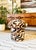 A handmade mushroom shaped ottoman, upholstered in "Serpentine" specialty fabric. Serpentine is a woven off-white fabric...