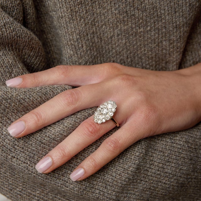 An exquisite example of turn-of-the-century elegance, this Edwardian navette ring dazzles with an elongated, marquise-...