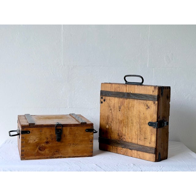 A pair of authentic vintage solid wood storage boxes with original black metal hardware and dovetail joints. Featuring a...