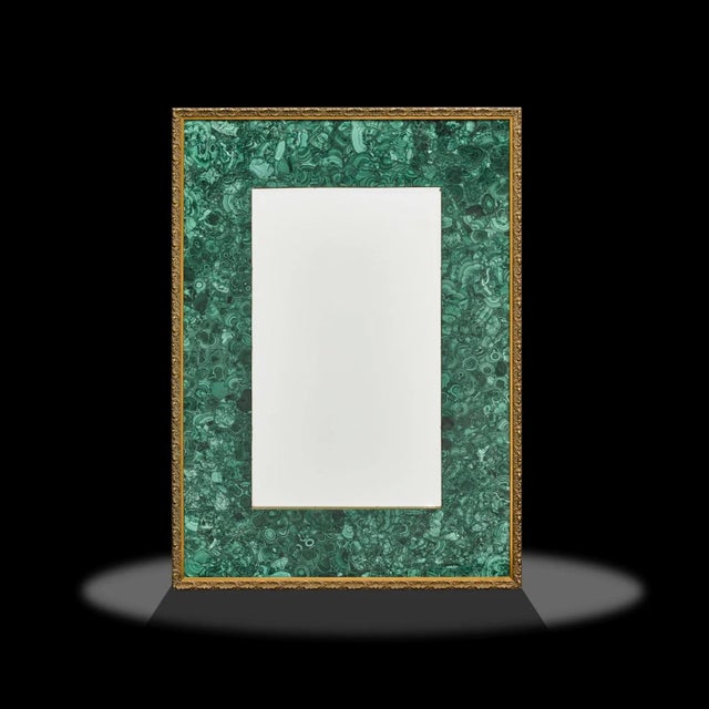 This is an incredible malachite mirror, very heavy and extremely well made, featuring an intarsia of malachite with brass...