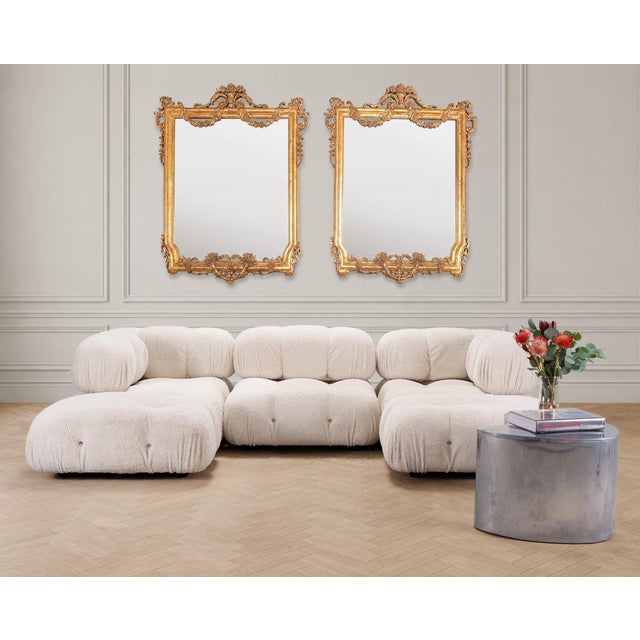 An elegant pair of late 19th/early 20th century French mirrors crafted in an exuberant Louis XVI Neoclassical style with...