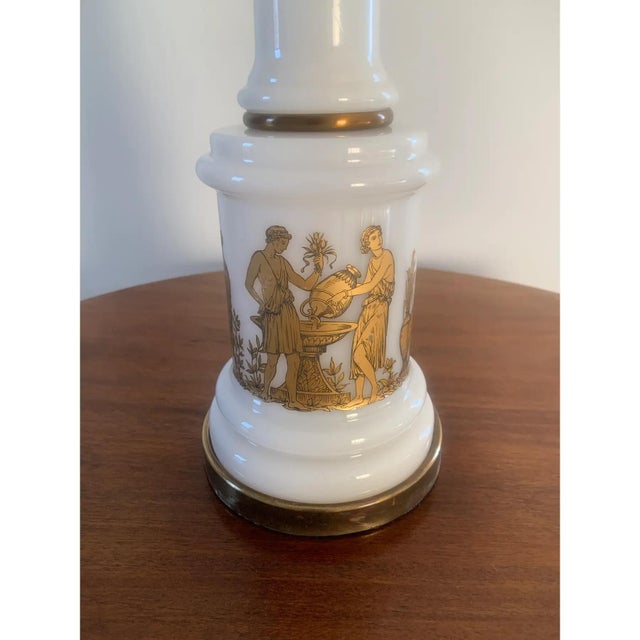 A stunning neoclassical or Hollywood Regency style white opaline table lamp featuring gold Greek figures dancing. This...