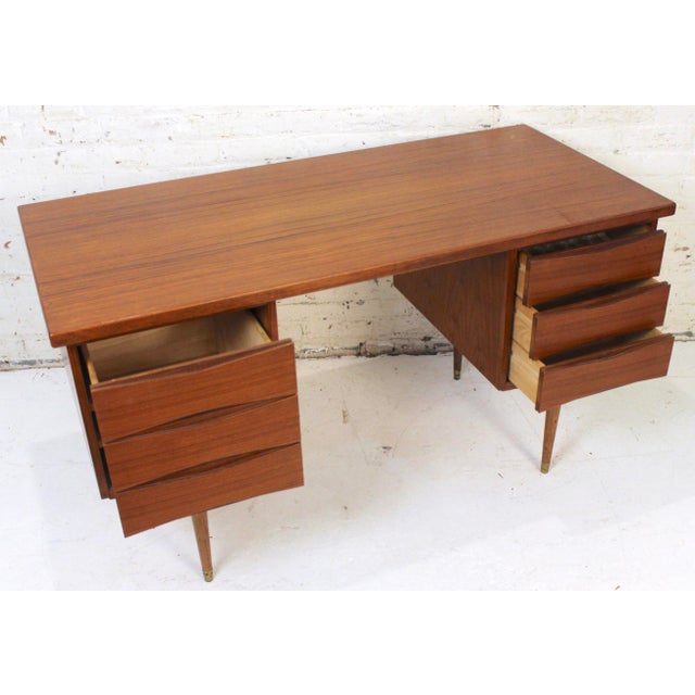 This stunning teak desk is in the Arne Vodder style. The piece features two large drawer pedestals, that provide ample...