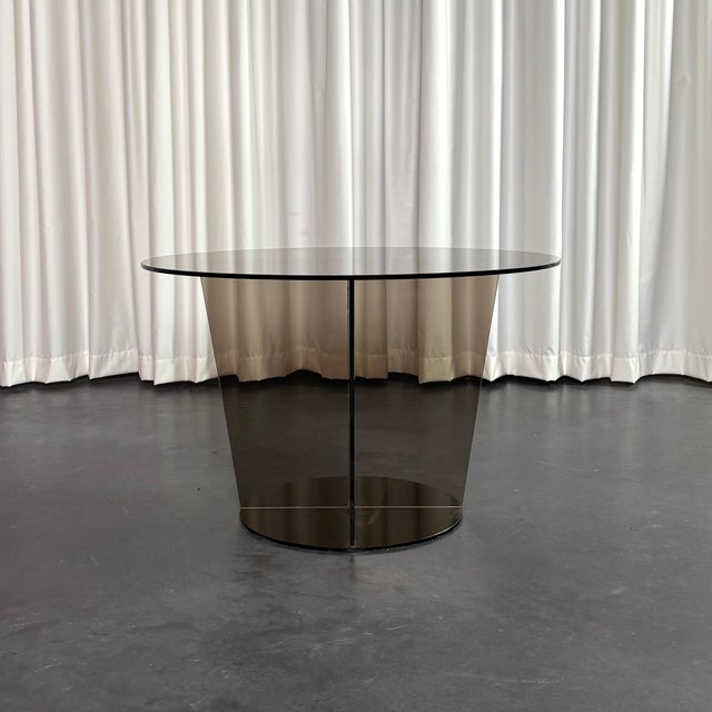 Round coffee table in smoked glass. This table is in good vintage condition but shows wear and patina consistent with age...