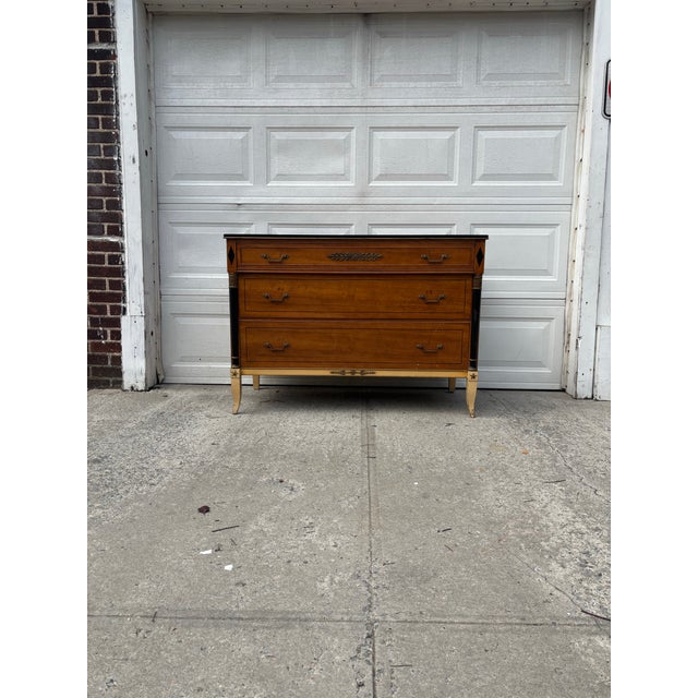 We have a beautiful vintage Neoclassical Empire Revival dresser for sale. It features brass mounts, ebonized columns,...