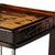 An airy, angular base of charcoal-burnished iron supports a squared tabletop of amber cast glass, perfectly sized to keep...