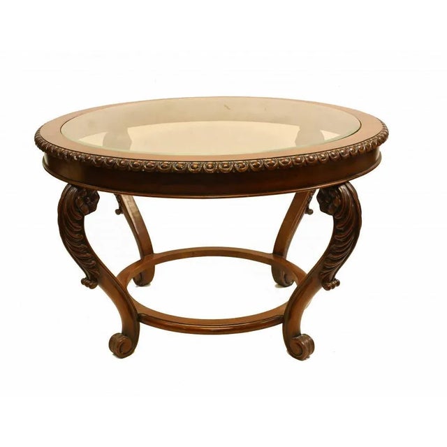 Cool Victorian style coffee table in mahogany. Glass topped with pie crust molding to the table top. Great interiors...