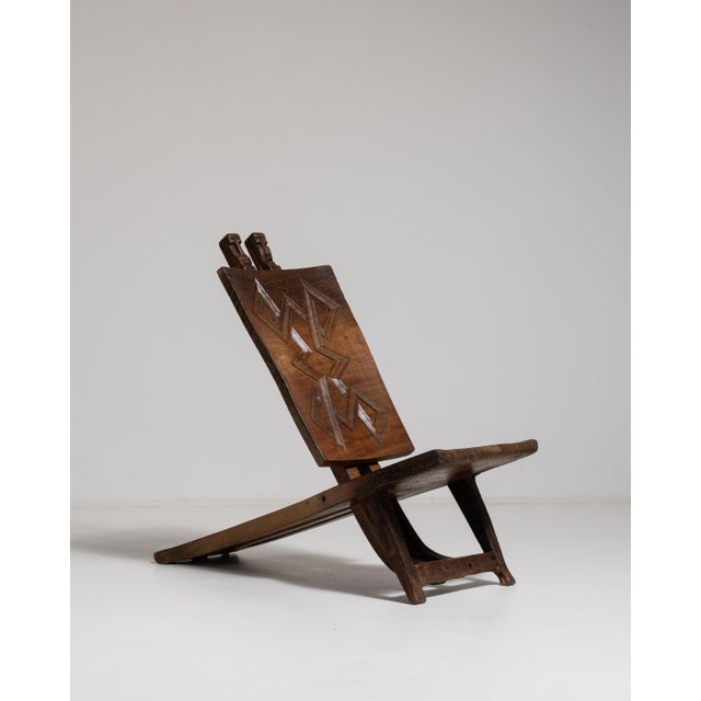 Rendered in warm, expressive hardwood, this commanding accent chair embodies the sculptural vitality of 20th-century...