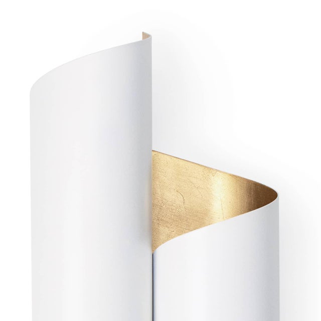 The Folio Sconce's exterior is uniquely contrasted by its almost paper-like metal that has been expertly formed to achieve...