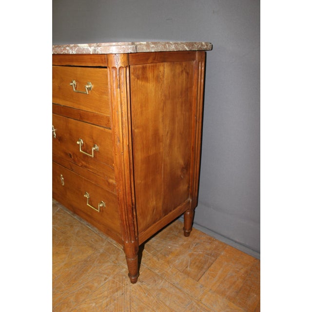 Small Louis XVI style chest of drawers in solid cherry wood, late 18th century, original marble top, fluted rounded...