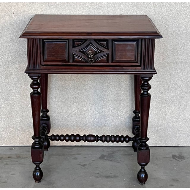 20th century pair of solid carved oak French nightstands with turned columns and stretcher. It has one carved drawer with...