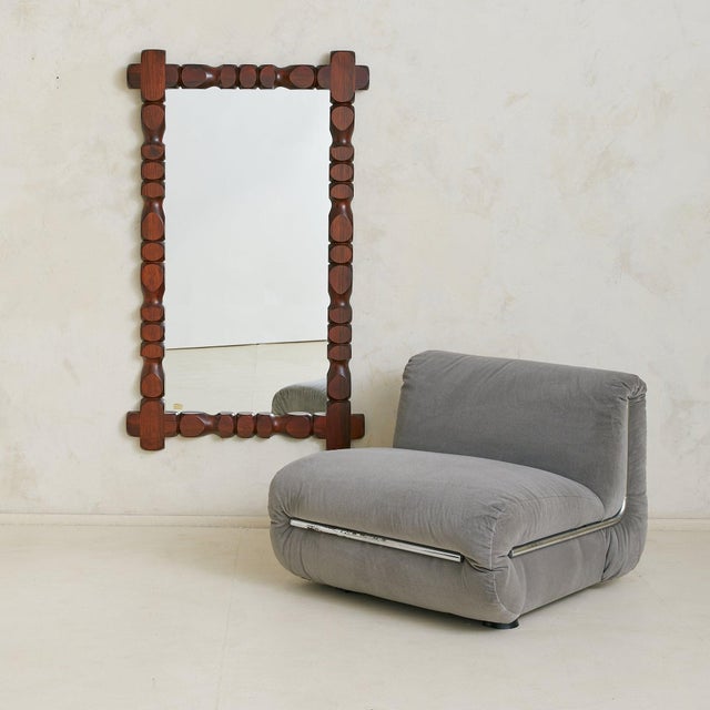 A 1970s Swedish wall mirror by Glas Mäster Markaryd. Crafted from hand-carved pine, the frame features rounded and faceted...