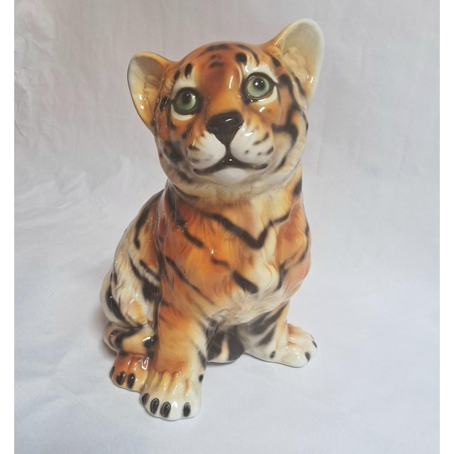 Hand-painted ceramic animal sculpture of a tiger cub with innocent eyes. Made in Italy in the 1970s.