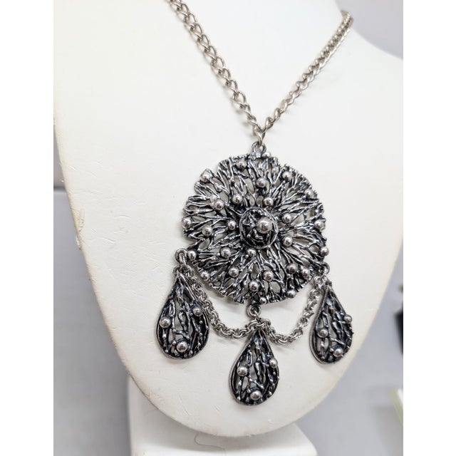 1972-1974 Brutalist silvertone round openwork with bumps center pendant with three tear drop shaped pendants of the same...
