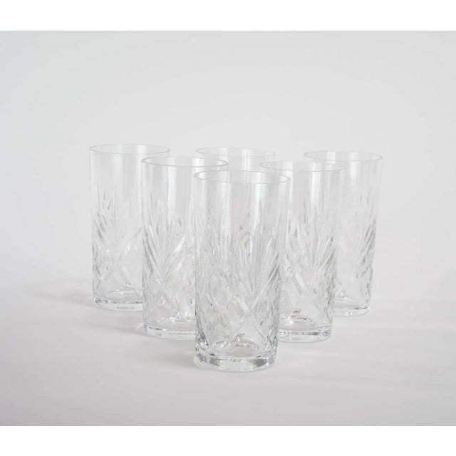 Richly hand cut and mouth blown barware and tableware glassware service for 12 people. Each glass features a deep cuts...