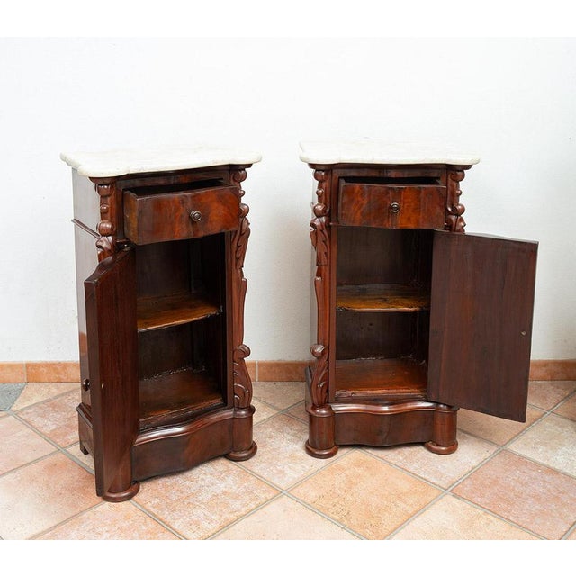 Pair of antique Louis Philippe Neapolitan bedside tables in mahogany with white Carrara marble tops. The curved front...