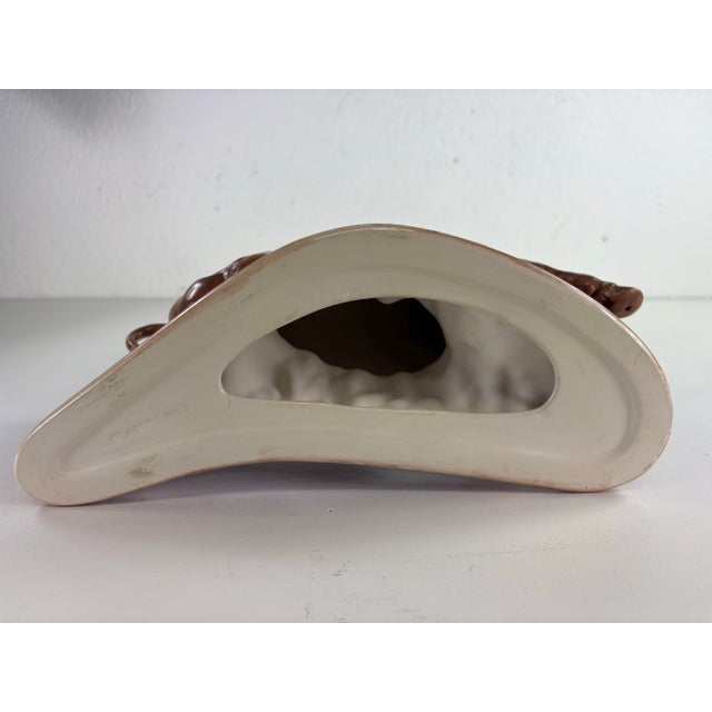 This is a mid-century vintage ceramic sculpture of a bull. This bull was sculpted in a dynamic pose. The sculpture has a...