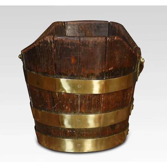 George III peat bucket with handle above the oak frame encased in brass bands. Dimensions Height 10.5 Inches Width 15...