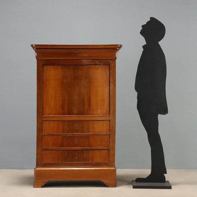 Carlo X style secretaire crafted in walnut, dating back to the second quarter of the 19th century, Italy. This elegant...