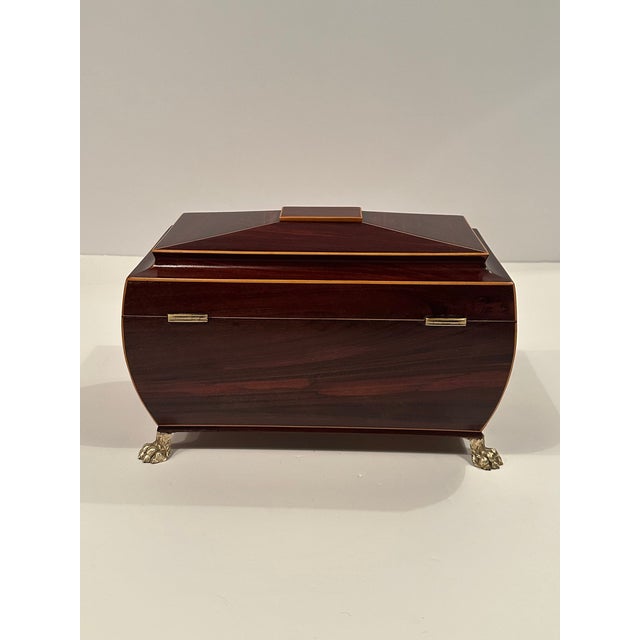 Sumptuous Regency style mahogany tea caddie having boxwood string inlay on the sides and handsome brass lion rings as well...